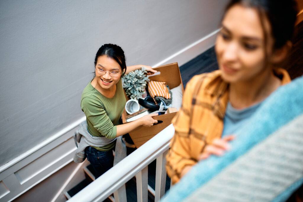 female friends carrying their belongings into a ne 2023 11 27 05 31 19 utc